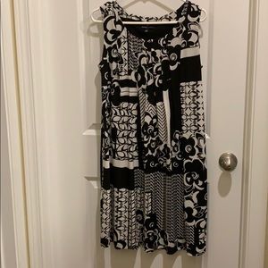 Flowing black and white sleeveless dress.